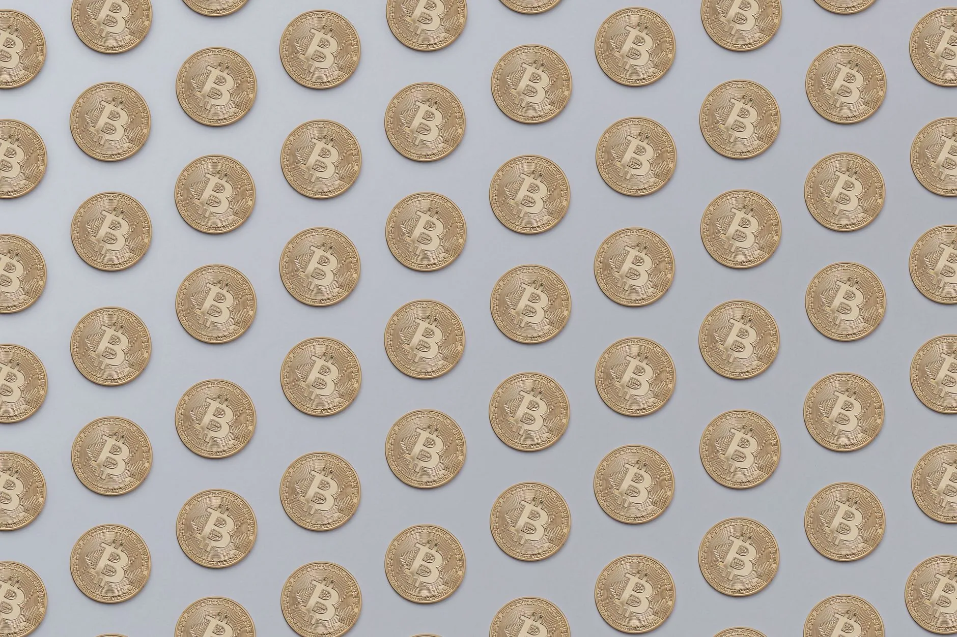 High-resolution image of golden Bitcoin coins arranged in a seamless pattern, ideal for financial or technological theme